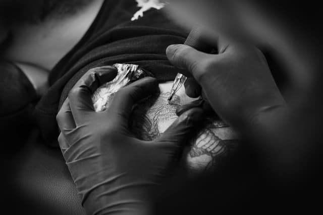 Artiste tatoueur au travail — studio Sang d'Encre à Metz